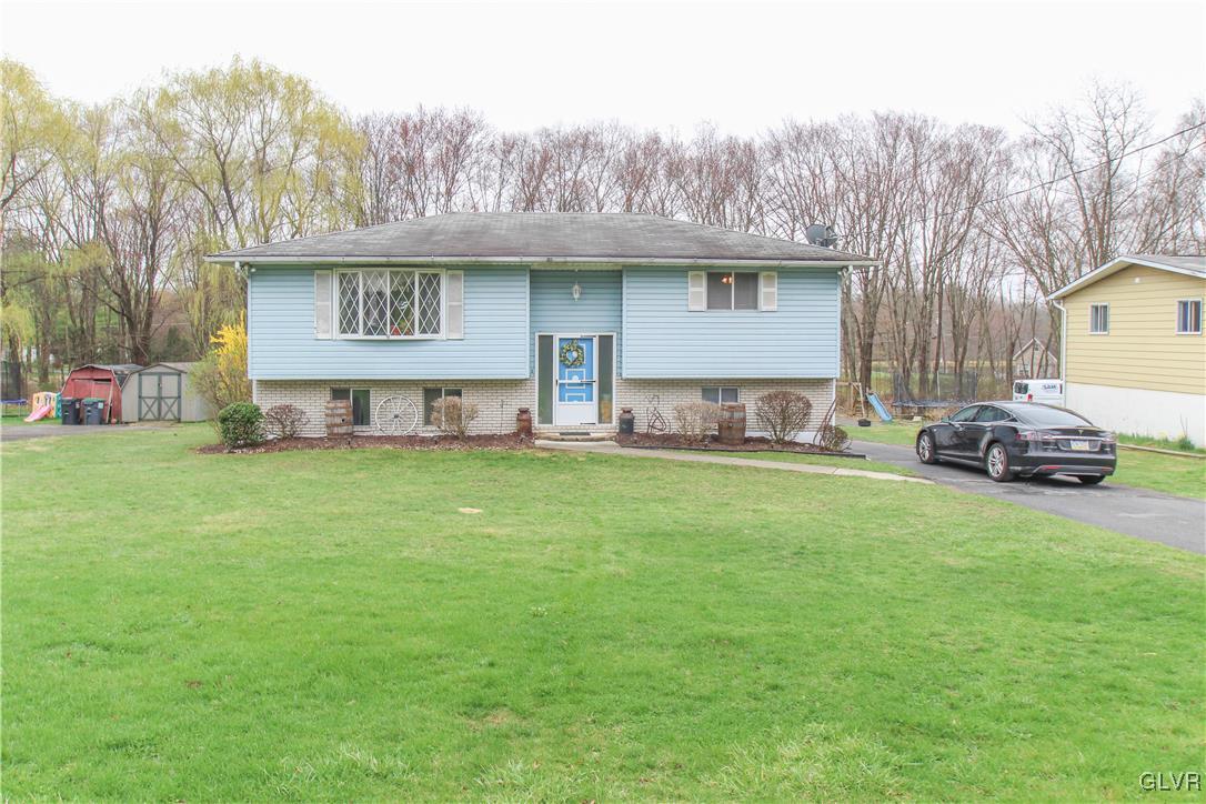3208 Cherry Road Kunkletown, PA 18058 - Photo 1 of 27 a front view of a house with a garden and tree