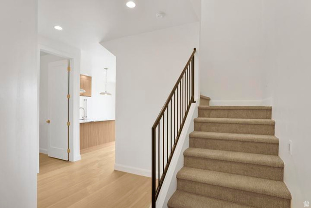 990 Manen Street Washington, UT 84780 - Photo 3 of 43 Carpeted staircase with an iron railing