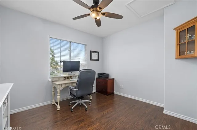 a view of a workspace with furniture and a window