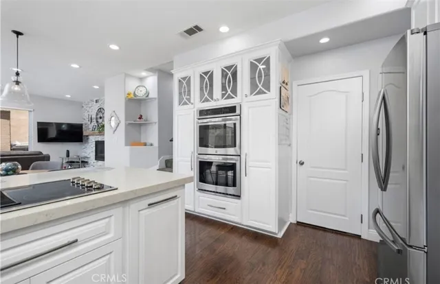 a kitchen with stainless steel appliances a refrigerator and a stove top oven