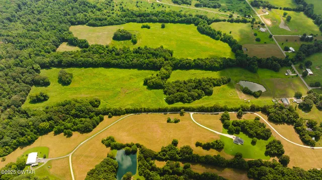 an aerial view of swimming pool a yard and green space