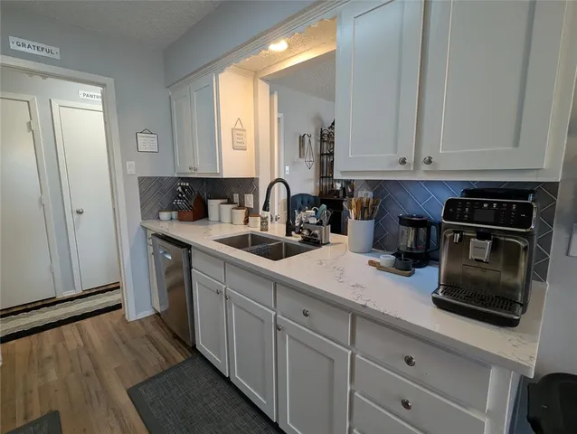 a kitchen with a sink and cabinets