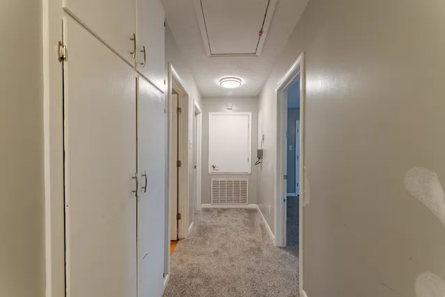 a view of a room with a ceiling fan and a window