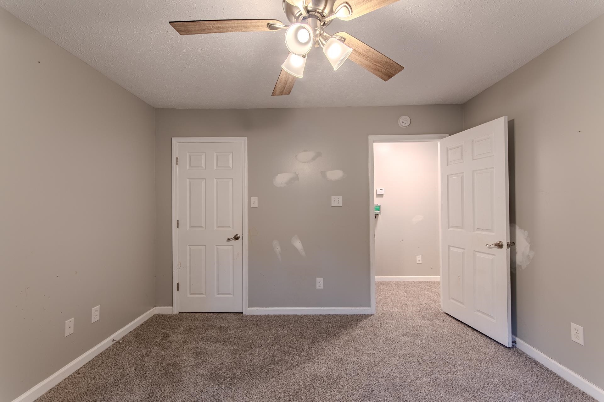 4985 Saltillo Road Saltillo, TN 38370 - Photo 22 of 40 an empty room with closet and a chandelier fan