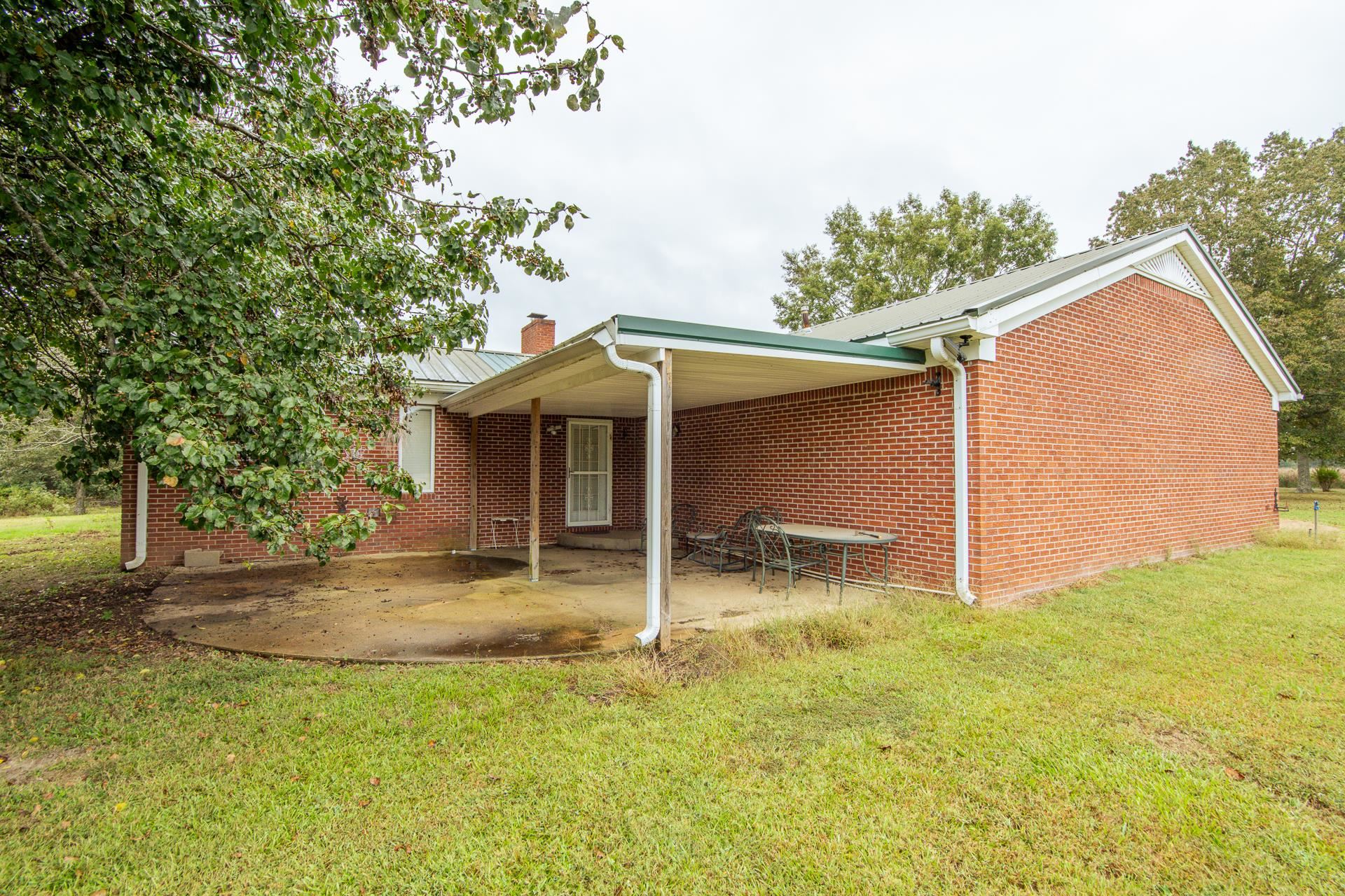 4985 Saltillo Road Saltillo, TN 38370 - Photo 30 of 40 a backyard of a house with table and chairs