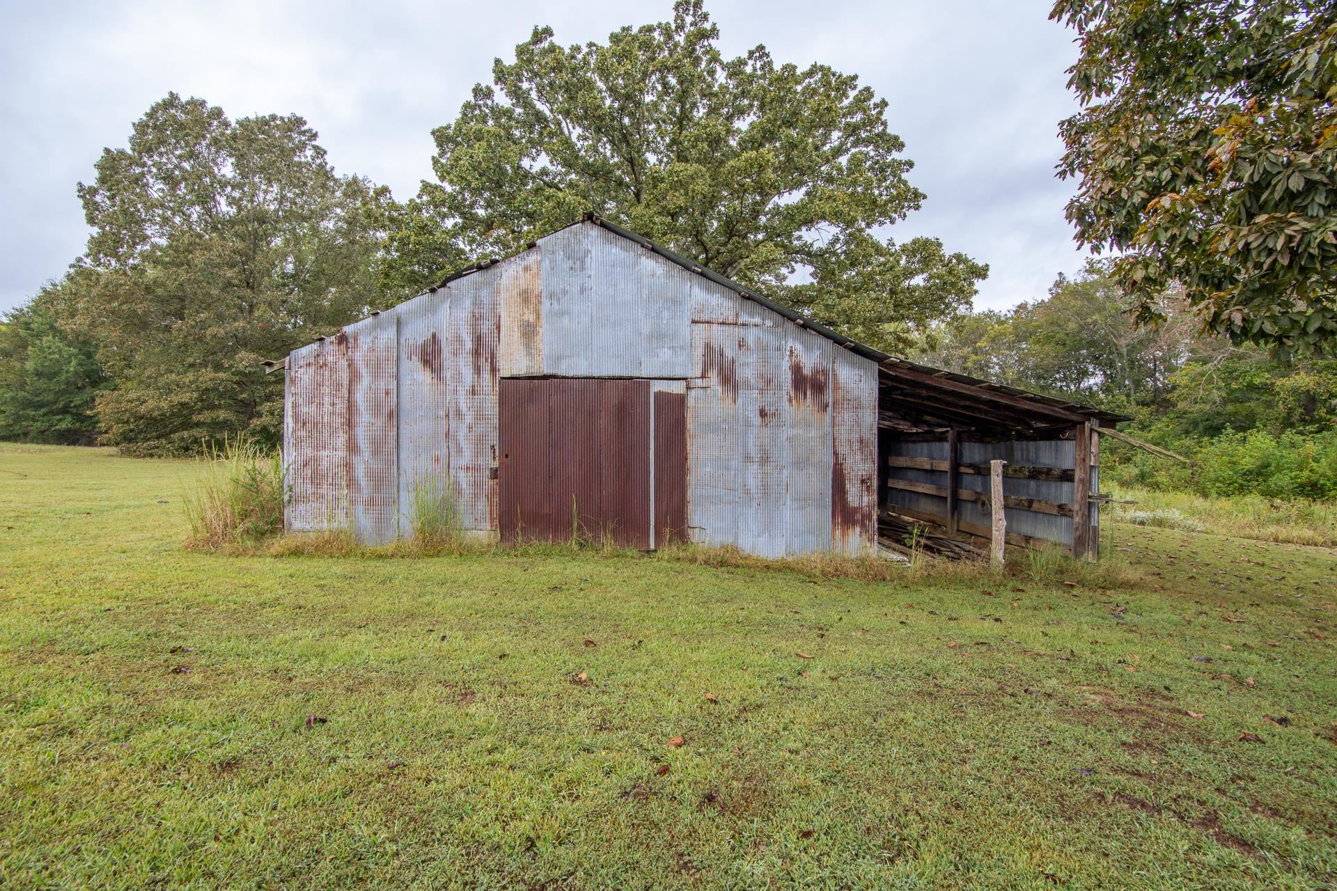 4985 Saltillo Road Saltillo, TN 38370 - Photo 34 of 40 a house with huge green field in front of it