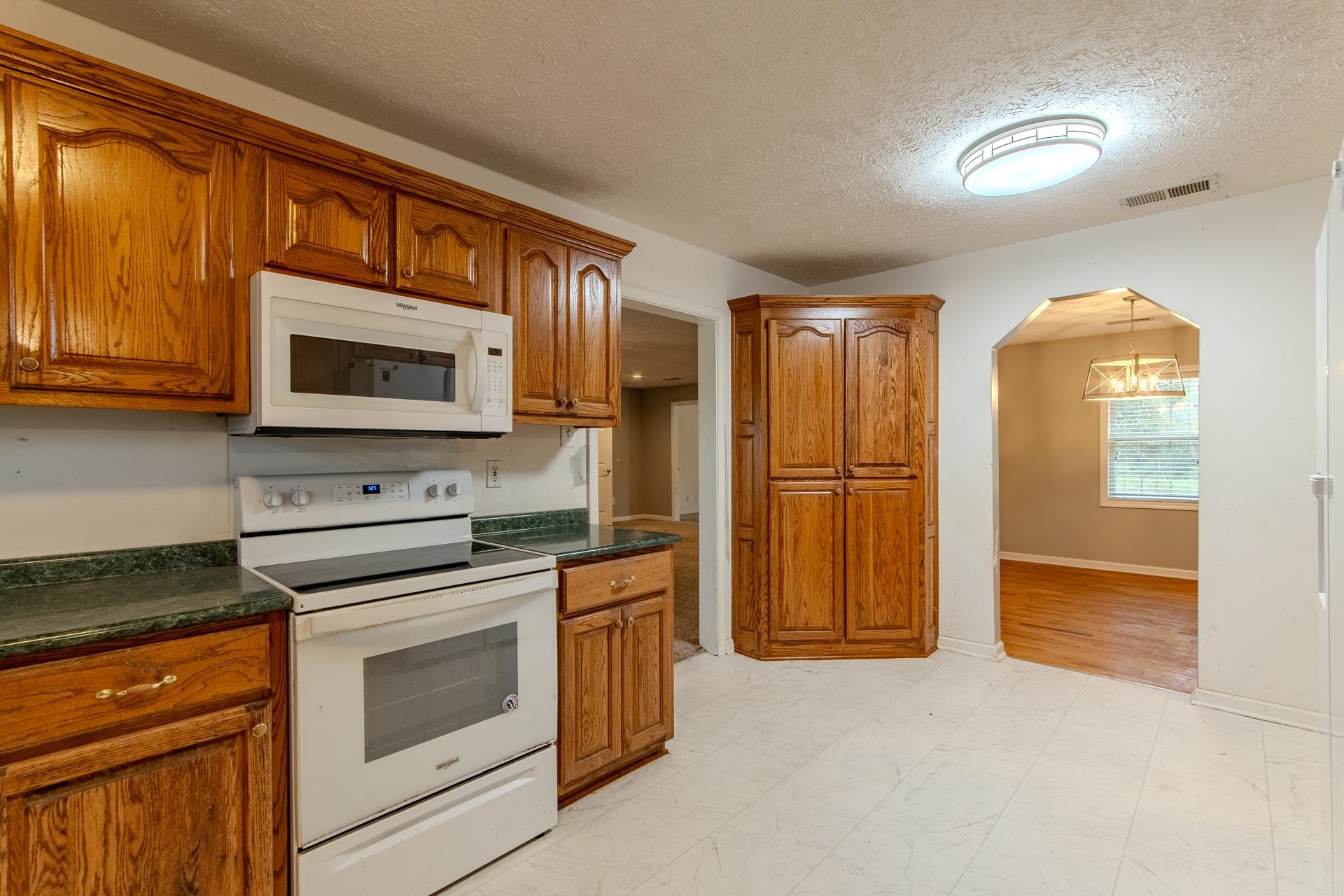 4985 Saltillo Road Saltillo, TN 38370 - Photo 10 of 40 a kitchen with stainless steel appliances granite countertop a refrigerator stove and sink