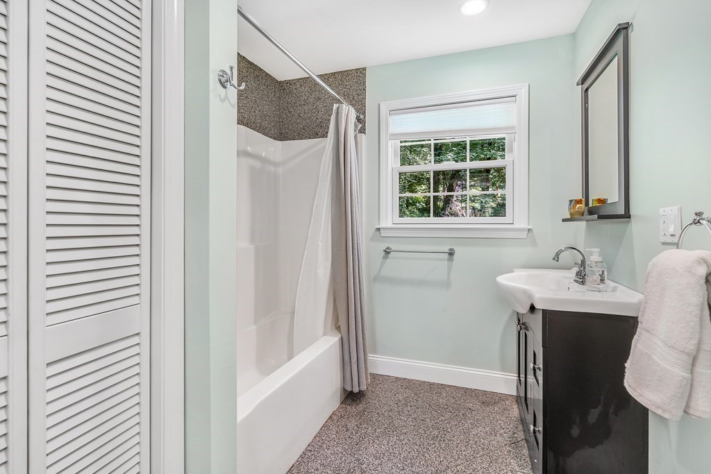 239 Sudbury Road Stow, MA 01775 - Photo 15 of 31 a bathroom with a granite countertop sink a mirror and a shower