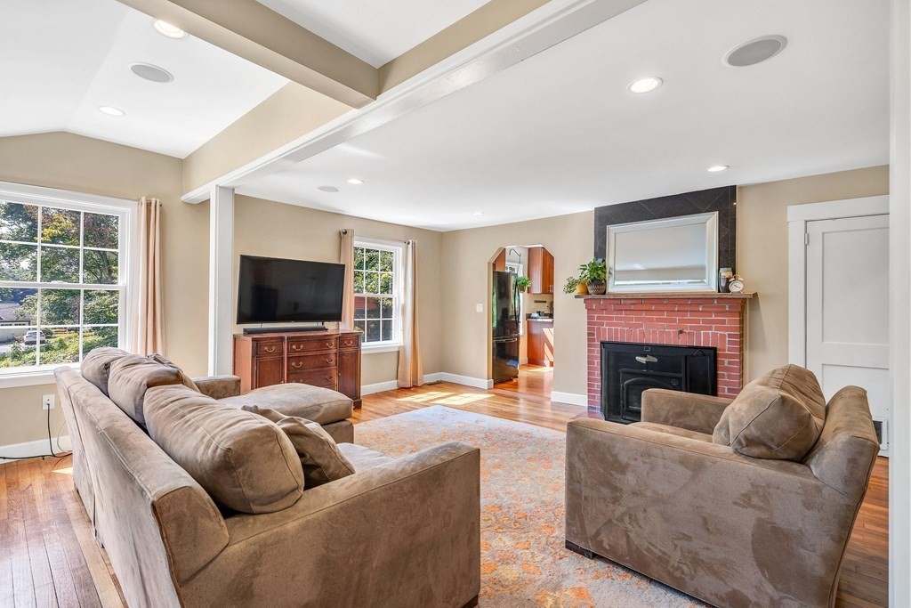 239 Sudbury Road Stow, MA 01775 - Photo 5 of 31 a living room with furniture a flat screen tv and a fireplace