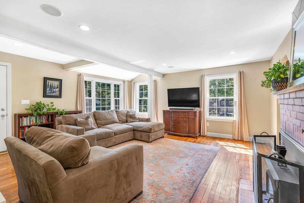 239 Sudbury Road Stow, MA 01775 - Photo 7 of 31 a living room with furniture a flat screen tv and a fireplace