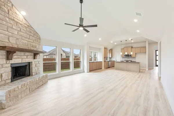a view of a kitchen with a sink and a fireplace
