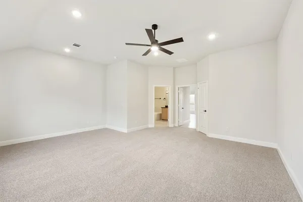 an empty room with closet and windows