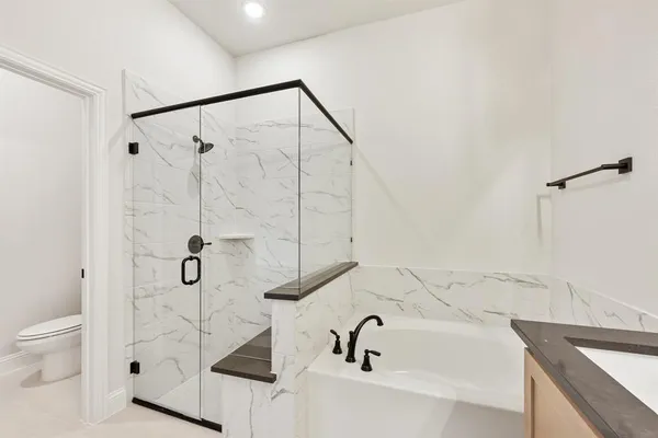 a bathroom with a sink and mirror with bathtub