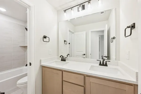 a bathroom with a sink a toilet and a bathtub