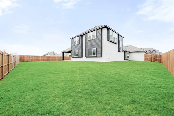 a front view of house with yard and car parked