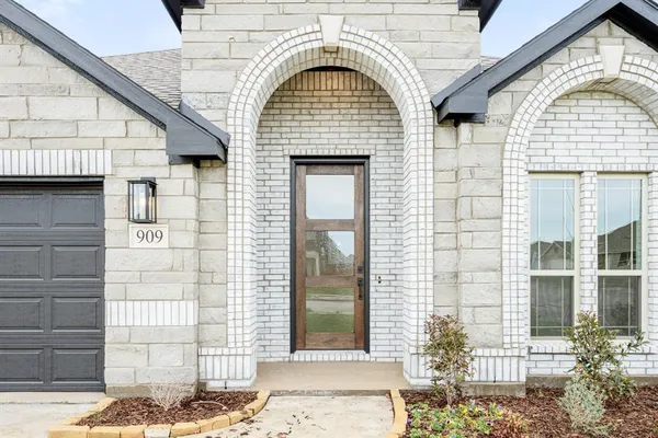 a view of a brick house with large windows