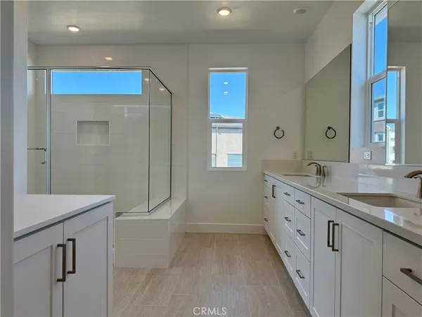 a bathroom with a granite countertop sink a toilet and mirror