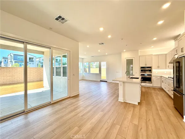 a view of kitchen with cabinets and wooden floor
