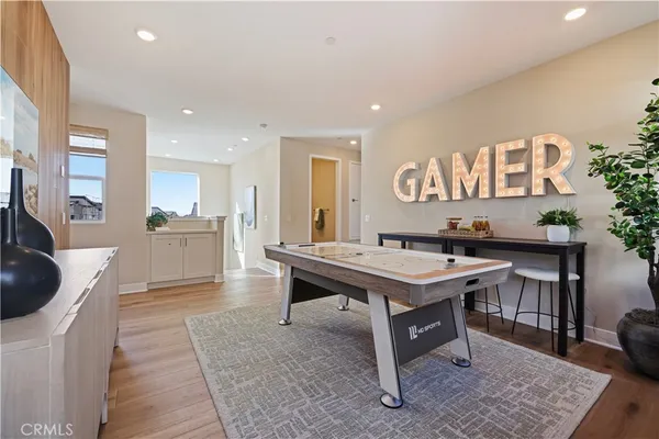 a room with furniture pool table and kitchen