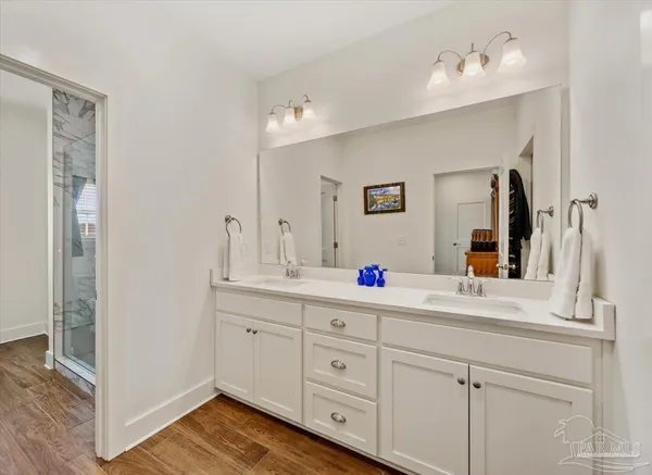 a bathroom with a double vanity sink and a mirror
