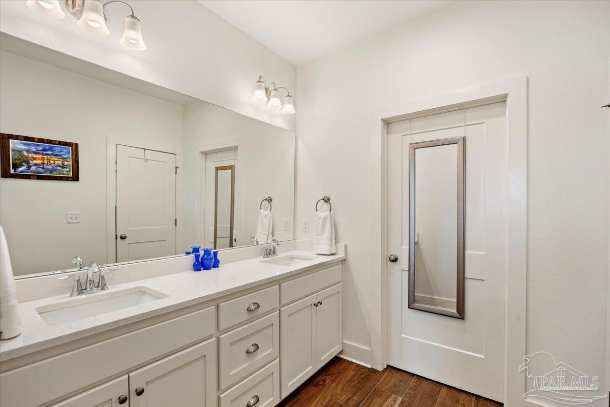 9303 Salter Road Pace, FL 32571 - Photo 13 of 23 a spacious bathroom with double sink a mirror and a shower