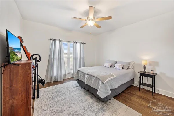 a bedroom with a bed closet and a window