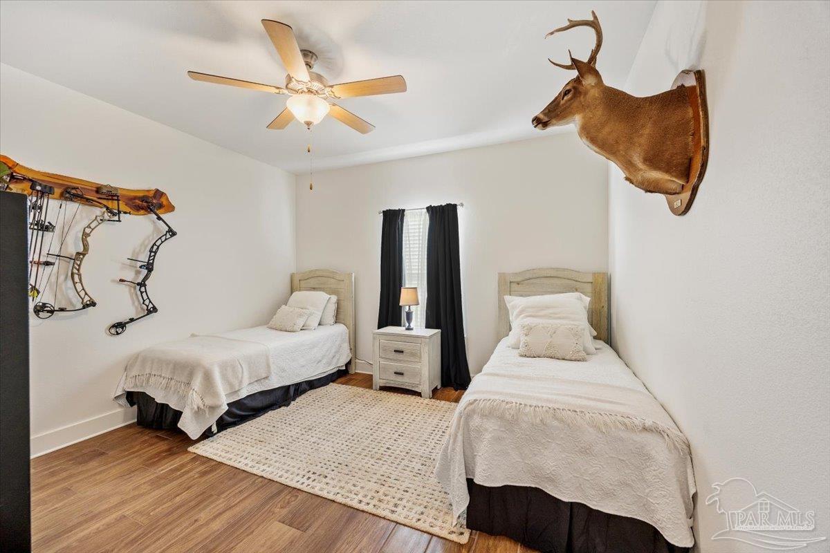 9303 Salter Road Pace, FL 32571 - Photo 16 of 23 a bedroom with a bed and window