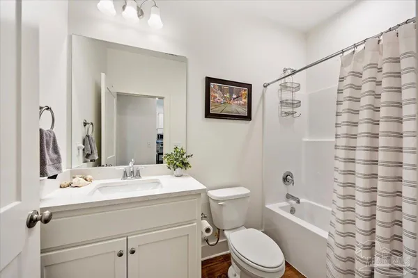 a bathroom with a sink mirror vanity and toilet