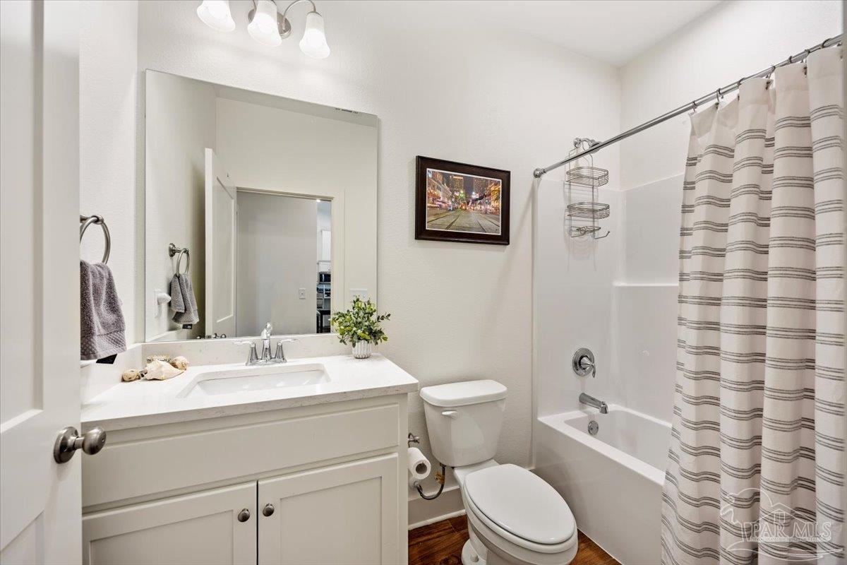 9303 Salter Road Pace, FL 32571 - Photo 17 of 23 a bathroom with a sink mirror vanity and toilet