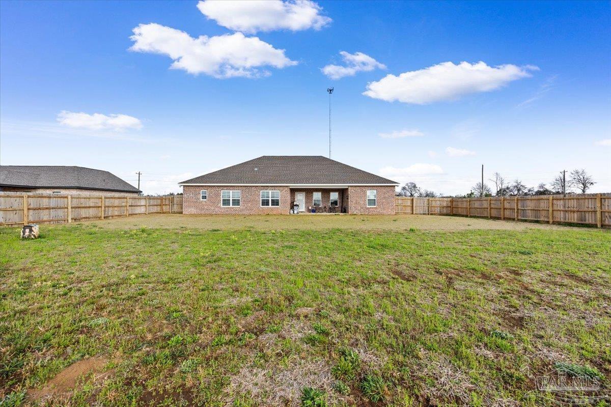 9303 Salter Road Pace, FL 32571 - Photo 19 of 23 a view of a big house with a big yard and large trees