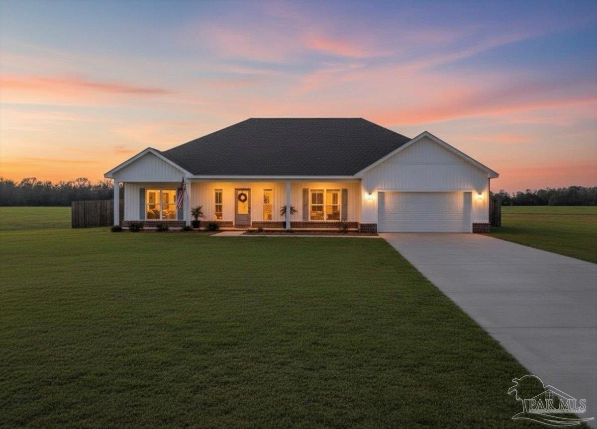 9303 Salter Road Pace, FL 32571 - Photo 2 of 23 a front view of a house with a garden