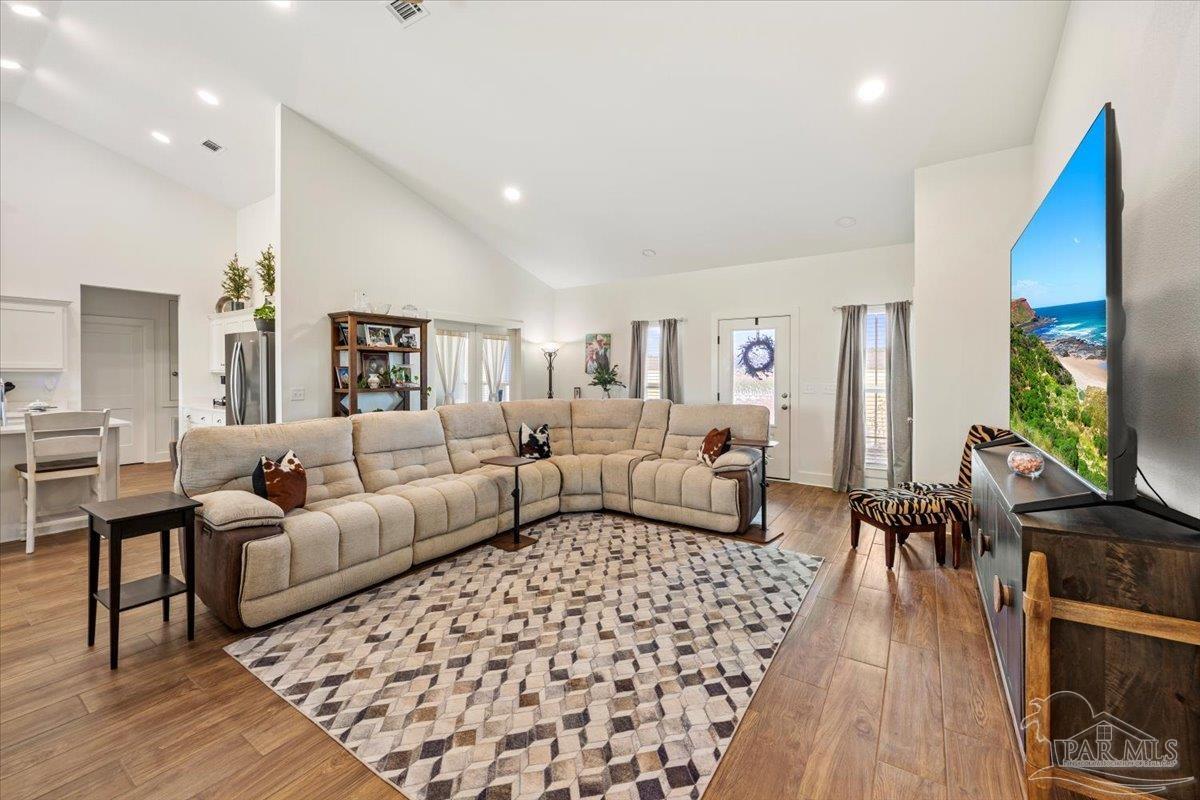 9303 Salter Road Pace, FL 32571 - Photo 3 of 23 a living room with furniture and a flat screen tv