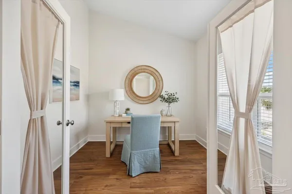 a view of a dining room with furniture and wooden floor