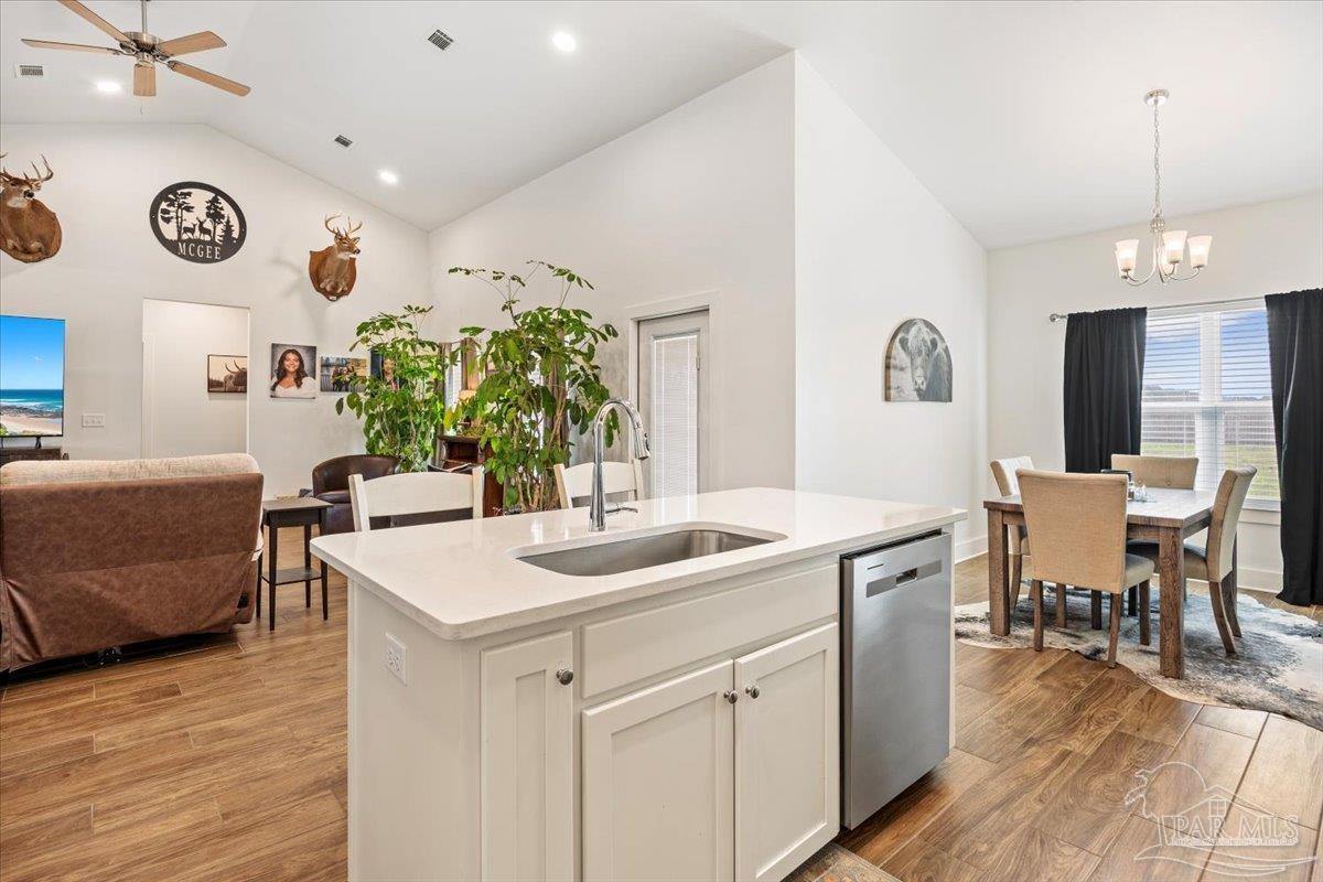 9303 Salter Road Pace, FL 32571 - Photo 7 of 22 a view of a kitchen area with furniture and wooden floor