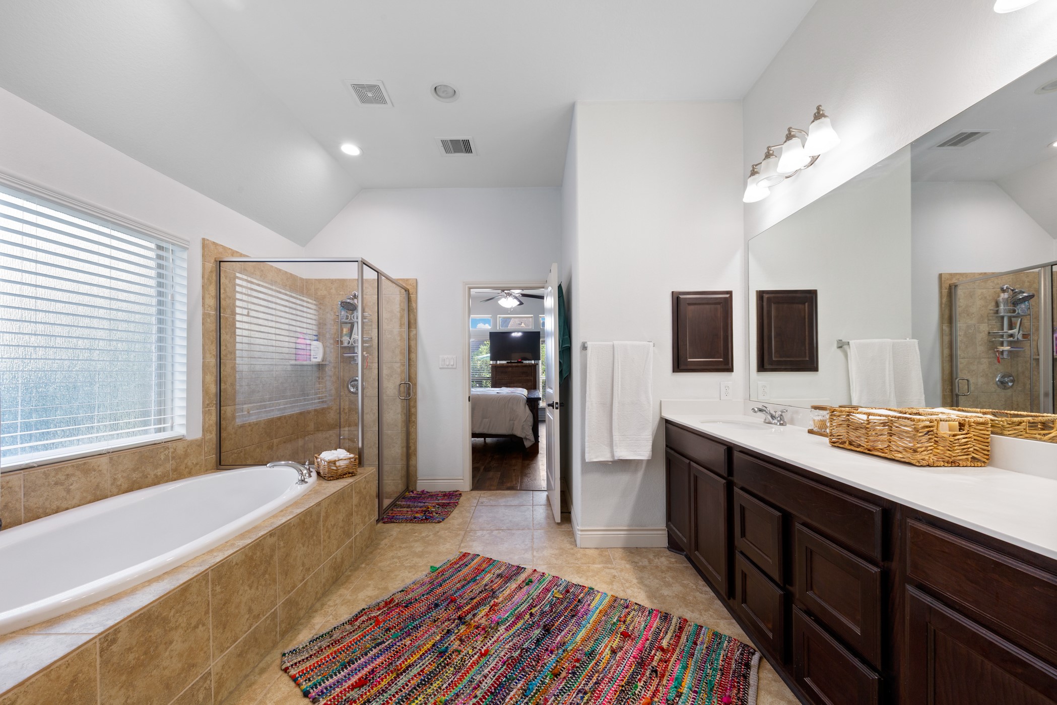 1235 Oxbow Crossing Lane Rosenberg, TX 77471 - Photo 24 of 34 a spacious bathroom with a double vanity sink a mirror a bathtub and shower