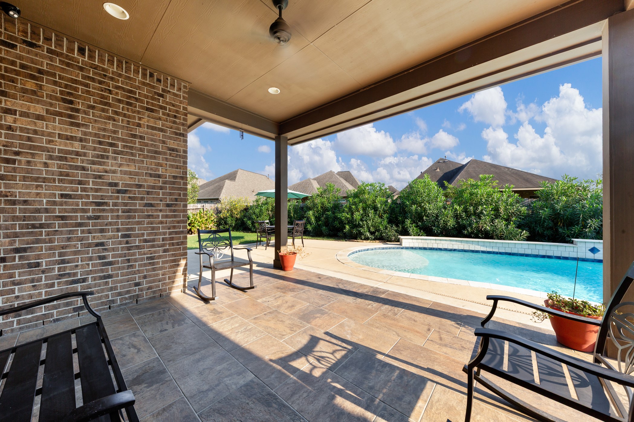 1235 Oxbow Crossing Lane Rosenberg, TX 77471 - Photo 26 of 34 a view of swimming pool with seating area and trees in the background