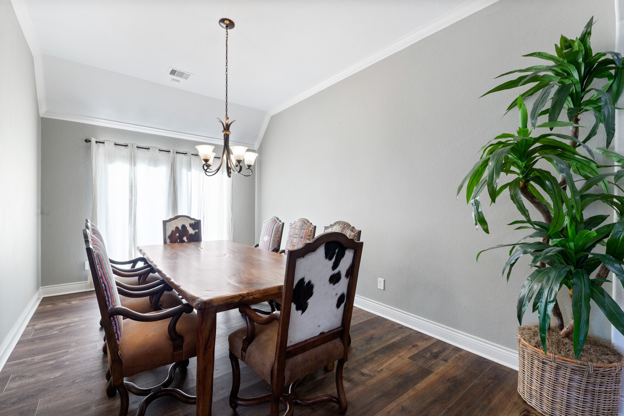 1235 Oxbow Crossing Lane Rosenberg, TX 77471 - Photo 5 of 34 a dining room with furniture potted plants and wooden floor