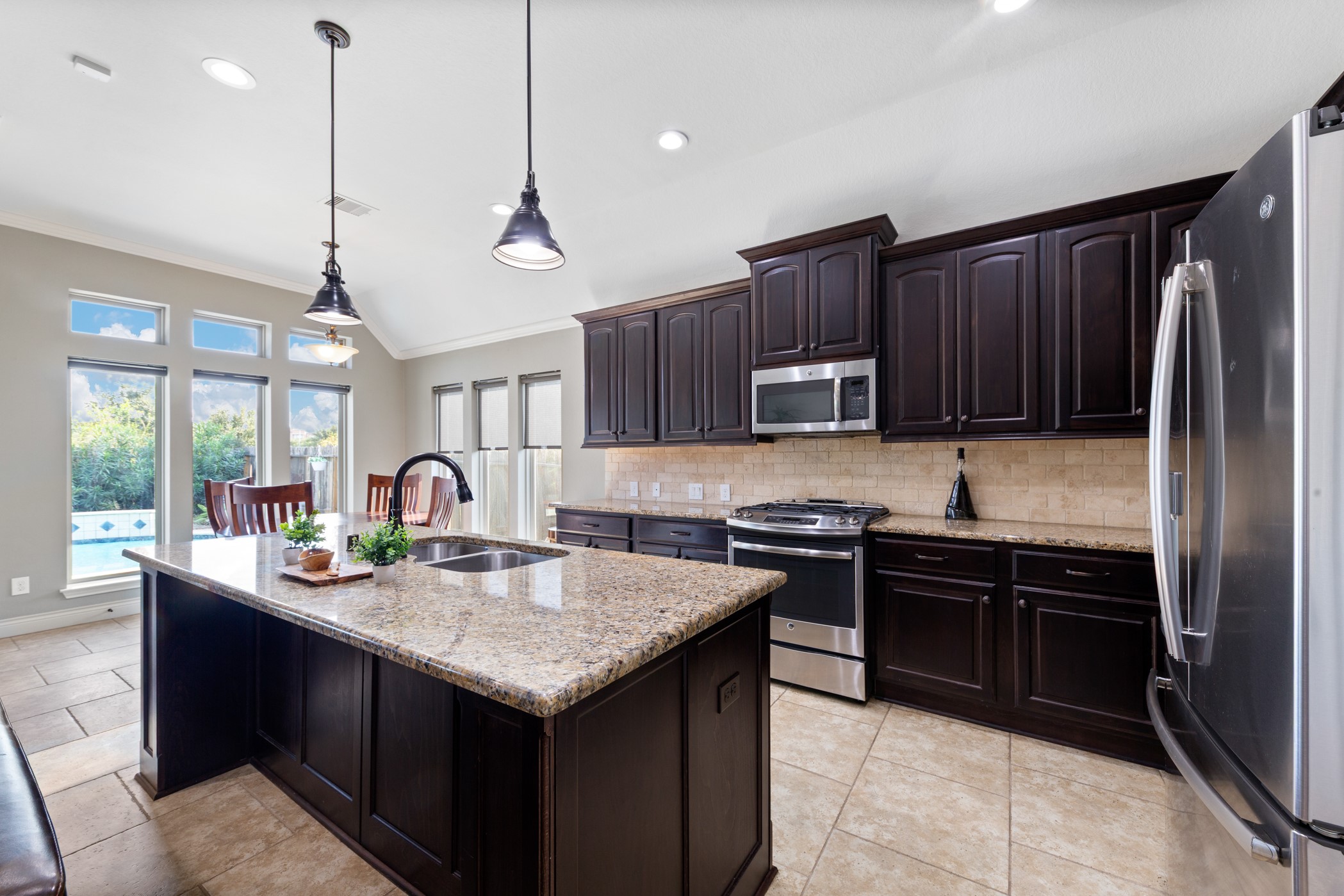 1235 Oxbow Crossing Lane Rosenberg, TX 77471 - Photo 6 of 34 a kitchen with granite countertop stainless steel appliances and wooden cabinets