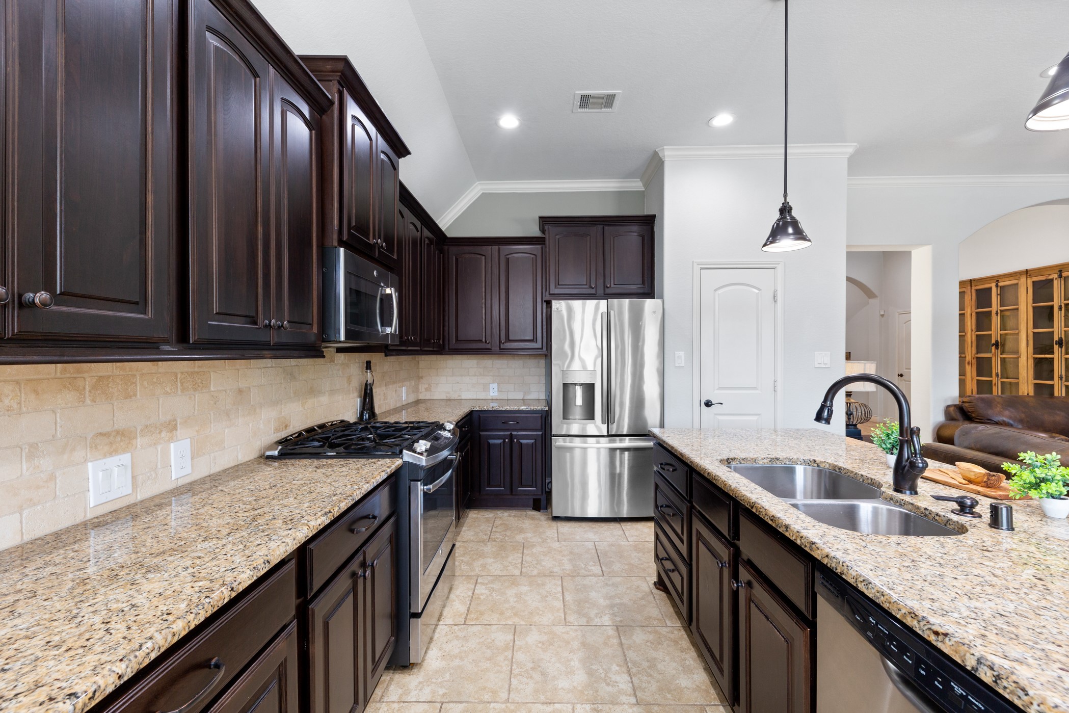 1235 Oxbow Crossing Lane Rosenberg, TX 77471 - Photo 7 of 34 a kitchen with stainless steel appliances granite countertop a sink a stove and a wooden floors