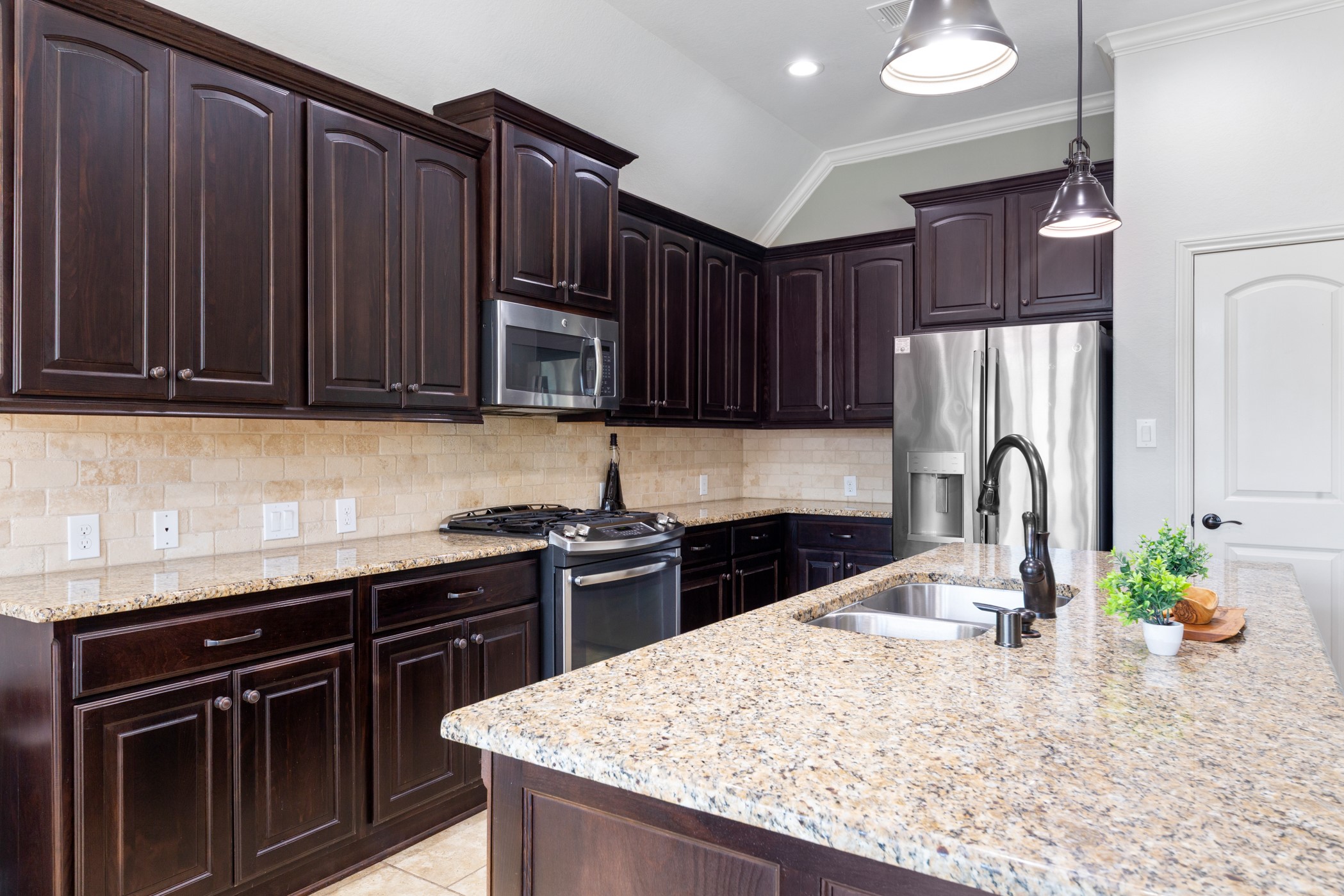 1235 Oxbow Crossing Lane Rosenberg, TX 77471 - Photo 9 of 34 a kitchen with granite countertop wood cabinets stainless steel appliances and a counter space