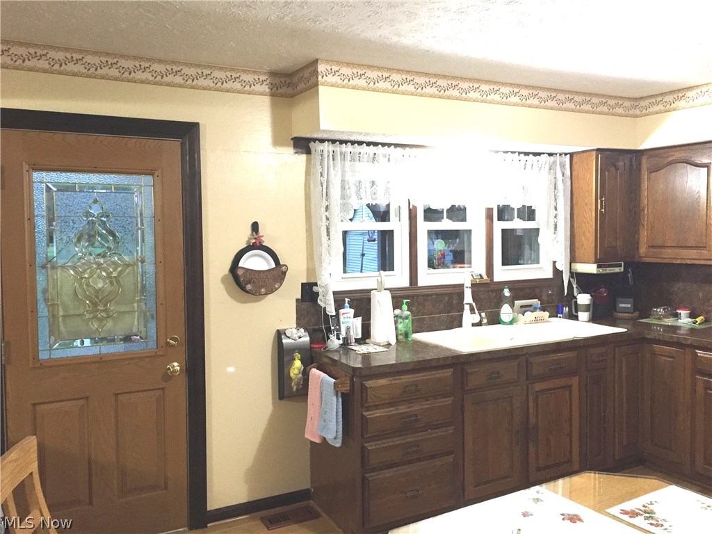 6474 Carsten Road Medina, OH 44256 - Photo 6 of 25 View #1 of the kitchen as you enter off the rear deck. Expansive cabinetry, plenty of drawers and ample counter space make preparing your daily meals a breeze. Plenty of room for your kitchen table.