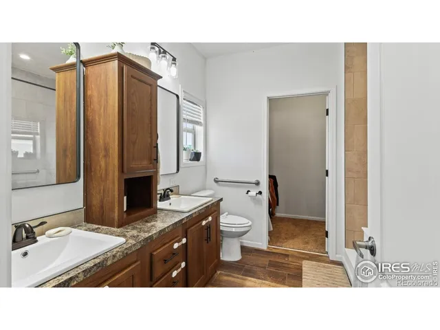 a bathroom with a sink double vanity and a toilet