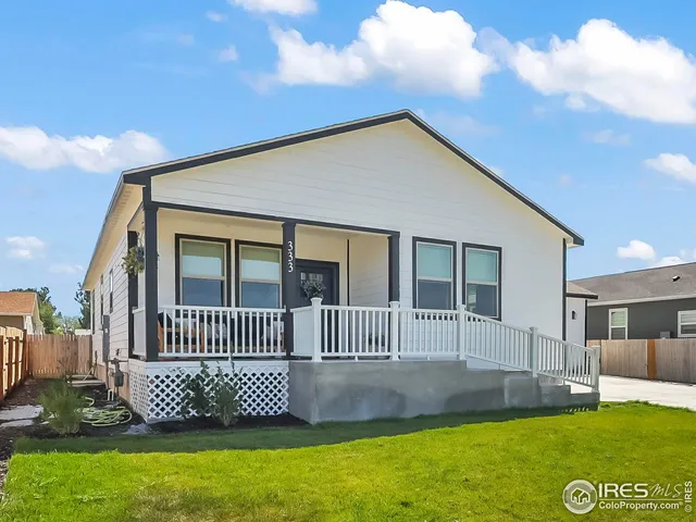 a front view of a house with a garden and deck