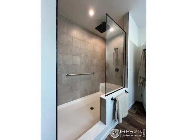 a bathroom with a glass door shower and a sink