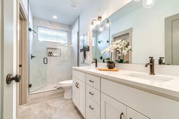 a bedroom with a large bed and a chandelier