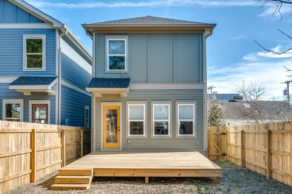 a view of backyard with wooden fence