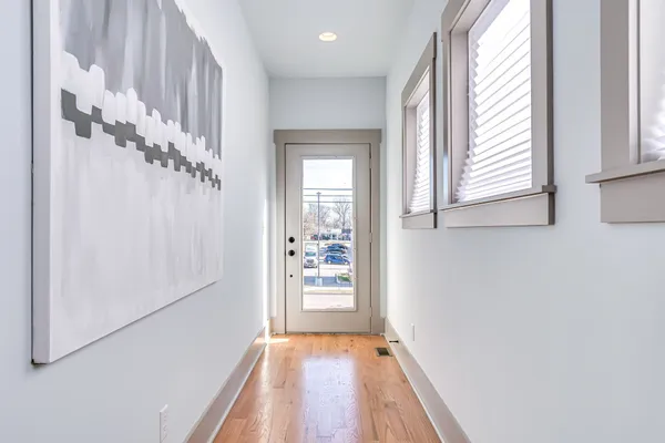 a view of a hallway view with wooden floor and staircase