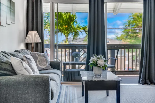 a living room with furniture and a potted plant