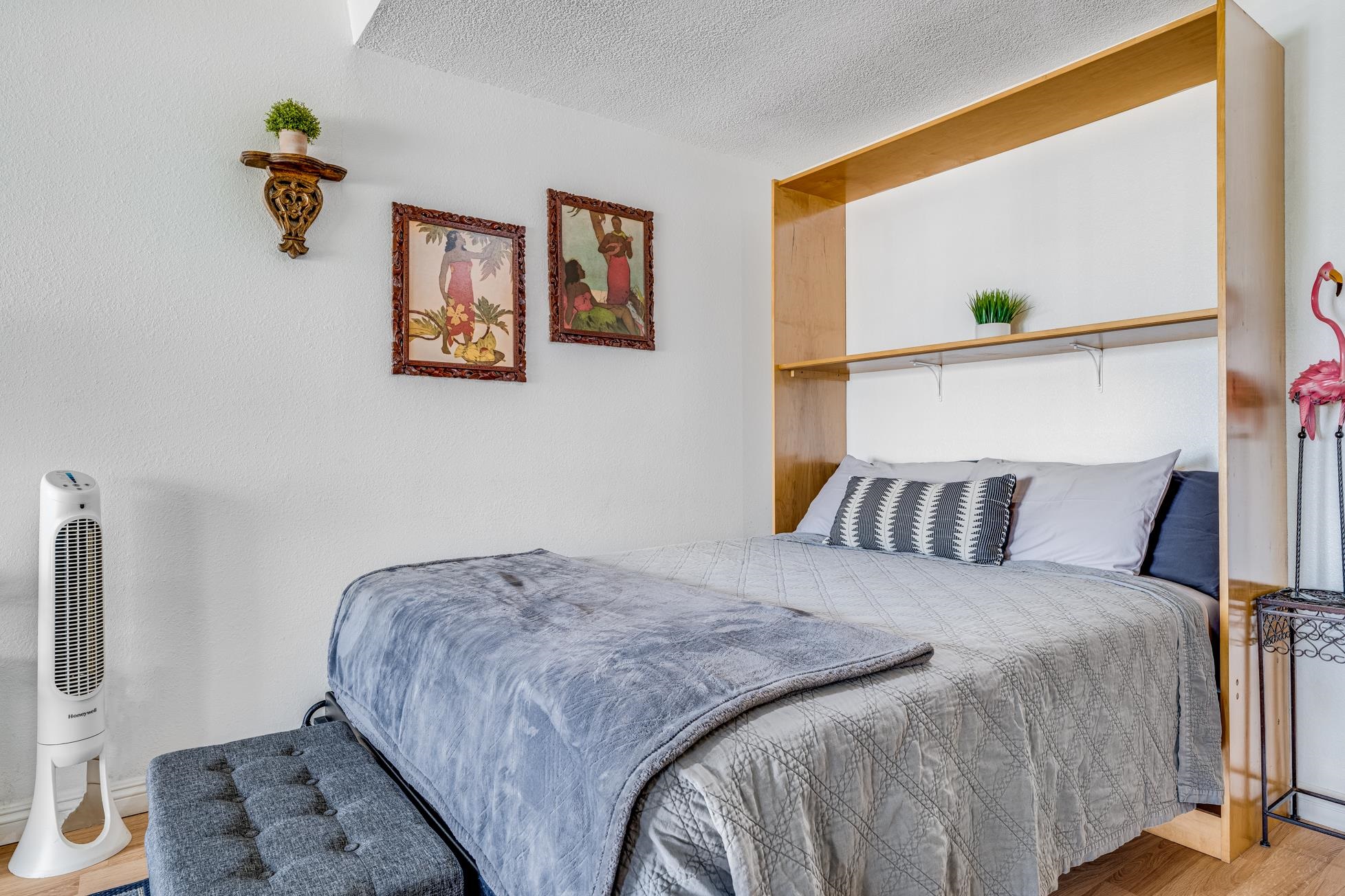 715 South Kihei Road, Unit A207 Kihei, HI 96753 - Photo 3 of 27 a bedroom with a bed and a painting on the wall