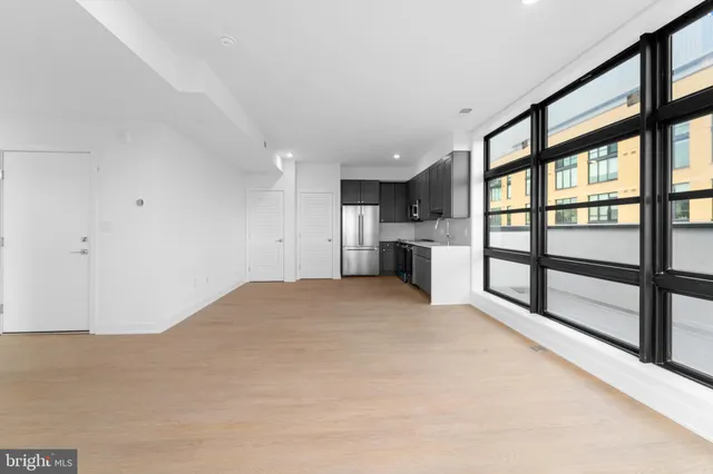a view of a kitchen with a sink and a refrigerator